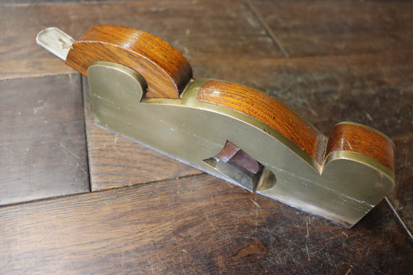Shoulder/Rebate Plane. Gunmetal with steel sole. Mahogany infill. Small chip to corner of mouth as shown. 46278